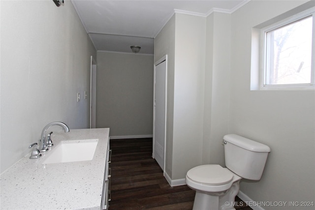 bathroom featuring hardwood / wood-style floors, vanity, toilet, and ornamental molding