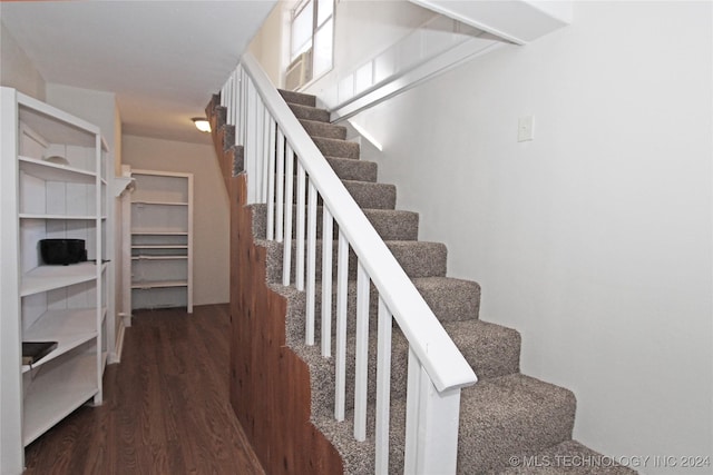 stairway with hardwood / wood-style flooring