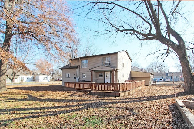 back of property featuring a wooden deck