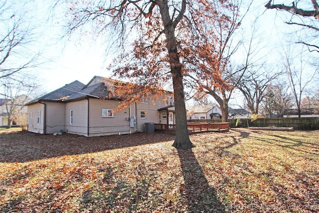 exterior space with a wooden deck, a yard, and central AC unit