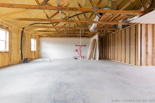 misc room featuring a garage and unfinished concrete flooring