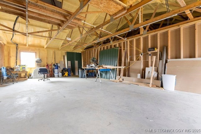 miscellaneous room with a garage and unfinished concrete floors