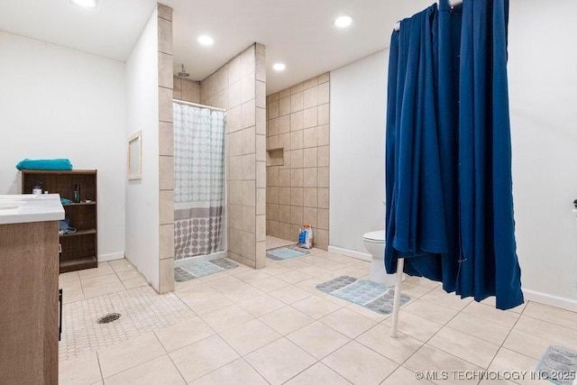 bathroom with toilet, tile patterned flooring, baseboards, and a tile shower