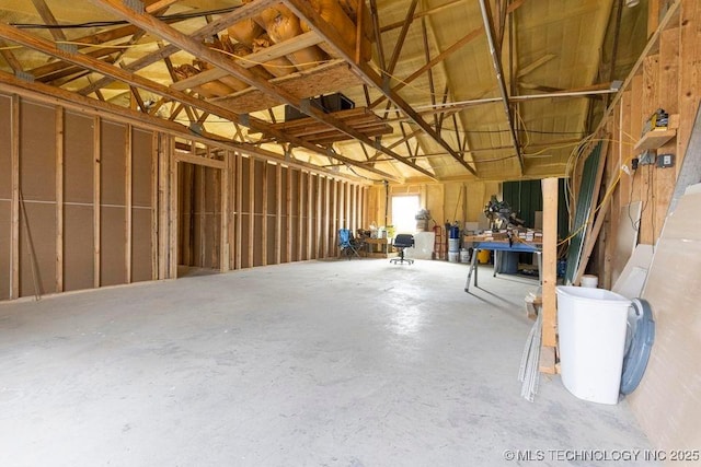 miscellaneous room with a garage and concrete floors