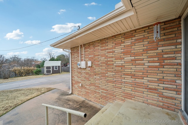 view of patio featuring a storage unit