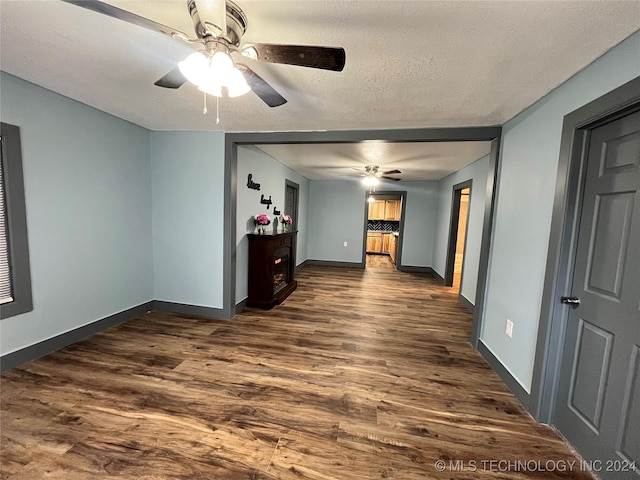 unfurnished living room featuring dark hardwood / wood-style floors and a textured ceiling