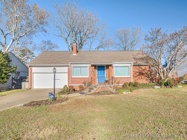 view of front of home with a front lawn and a garage