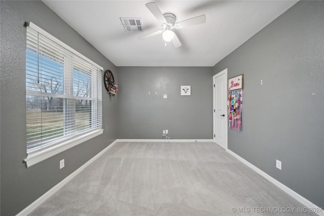 carpeted empty room with ceiling fan