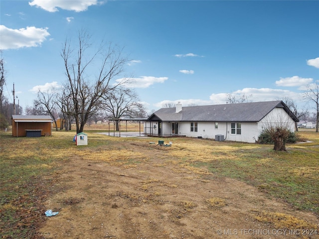 view of yard with central AC unit and a storage unit