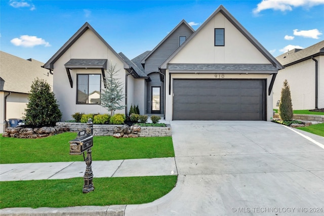 view of front of house featuring a garage and a front yard