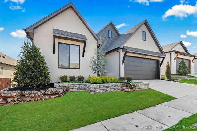 view of front facade featuring a garage and a front lawn