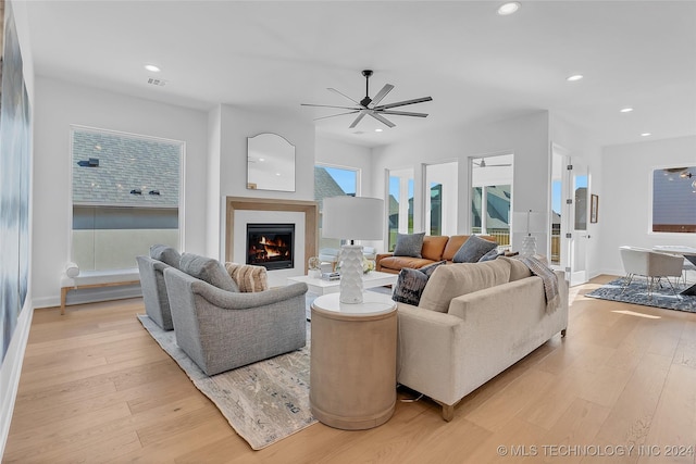 living room featuring ceiling fan and light hardwood / wood-style flooring