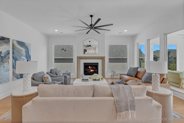 living room featuring ceiling fan and light wood-type flooring