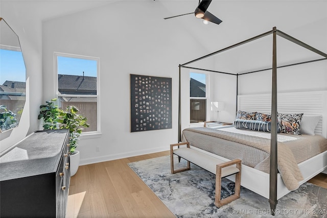 bedroom with hardwood / wood-style flooring, ceiling fan, high vaulted ceiling, and multiple windows