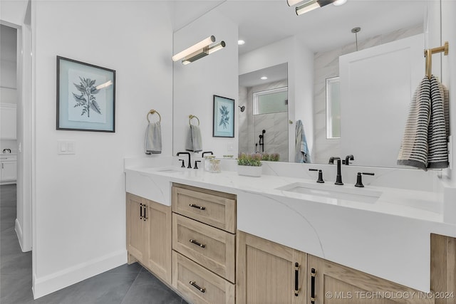 bathroom with vanity and a tile shower