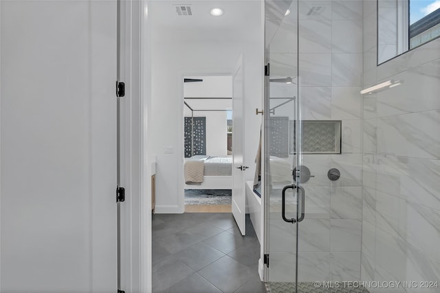 bathroom featuring tile patterned floors and a shower with door