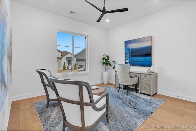 home office with ceiling fan and light hardwood / wood-style floors