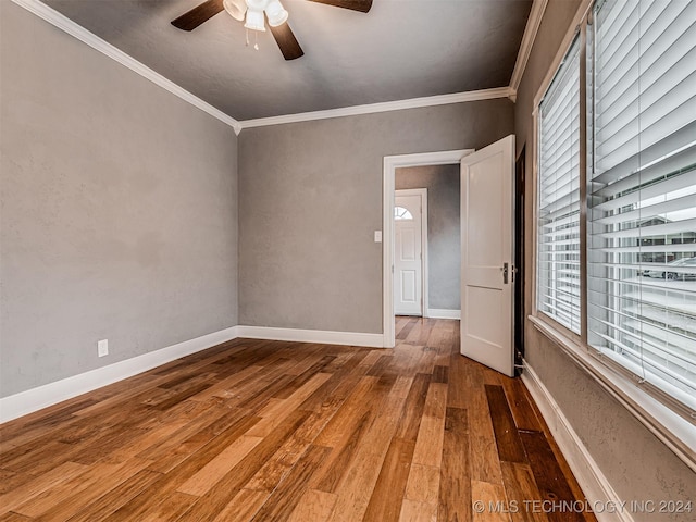 spare room with ceiling fan, ornamental molding, and hardwood / wood-style floors