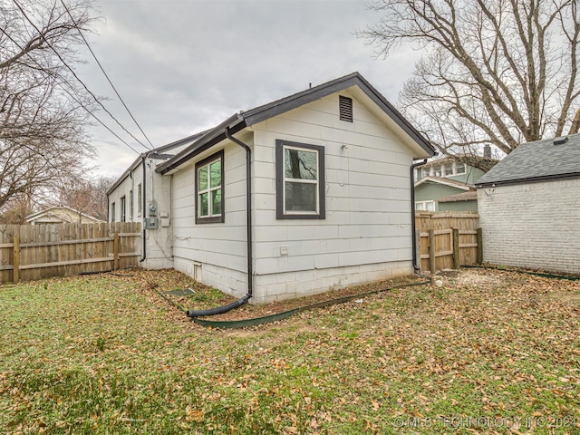 view of property exterior featuring a lawn