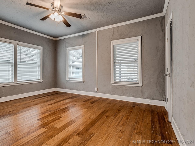 unfurnished room with ceiling fan, crown molding, a textured ceiling, and hardwood / wood-style flooring