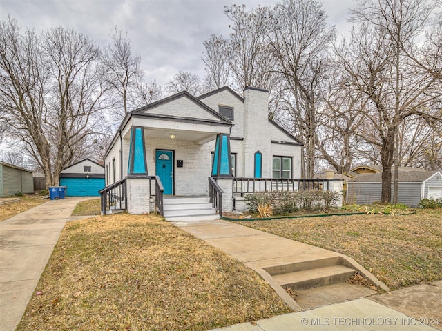 view of front of house with covered porch and a front yard