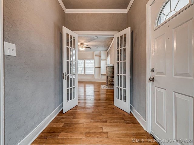 foyer featuring ceiling fan, light hardwood / wood-style floors, crown molding, and french doors