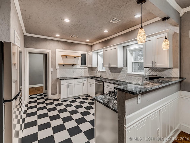 kitchen featuring kitchen peninsula, appliances with stainless steel finishes, white cabinets, and sink