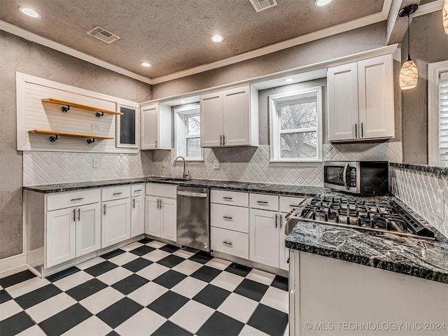 kitchen featuring white cabinets, crown molding, and stainless steel appliances