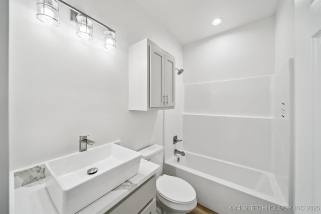 full bath featuring shower / washtub combination, toilet, and vanity