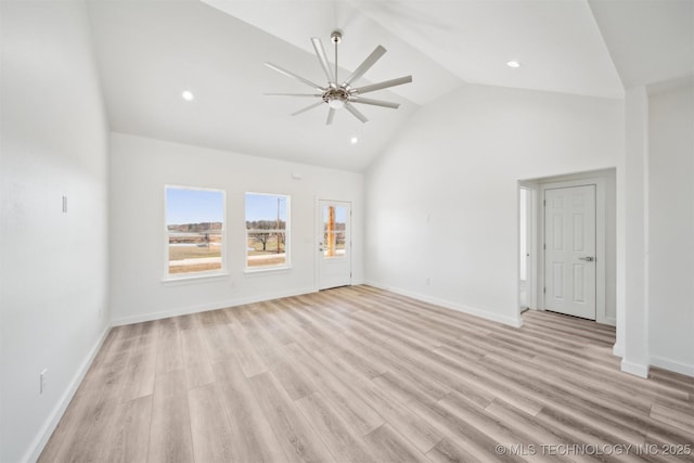 unfurnished living room with high vaulted ceiling, a ceiling fan, recessed lighting, light wood-style floors, and baseboards