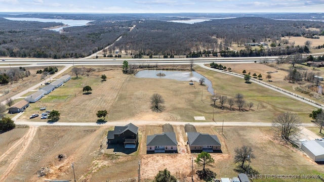 drone / aerial view featuring a water view and a rural view