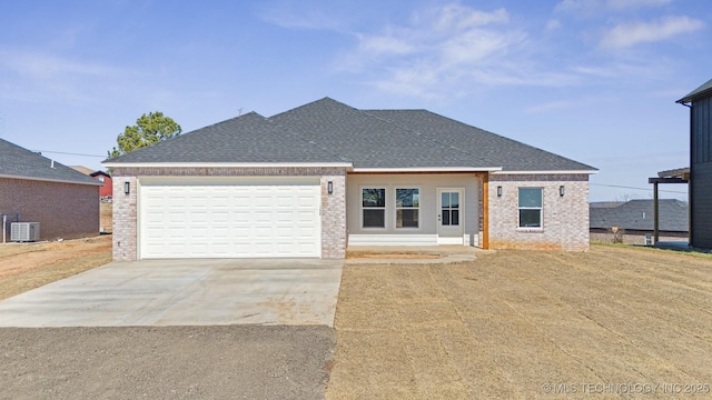 view of front of home with brick siding, cooling unit, concrete driveway, and roof with shingles