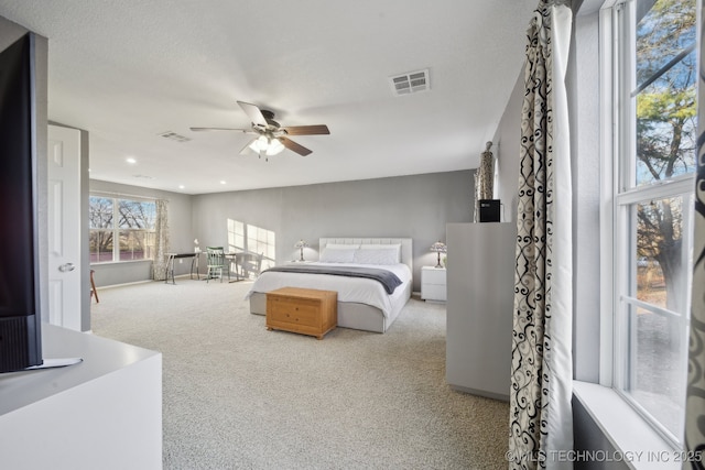 bedroom featuring light carpet and ceiling fan