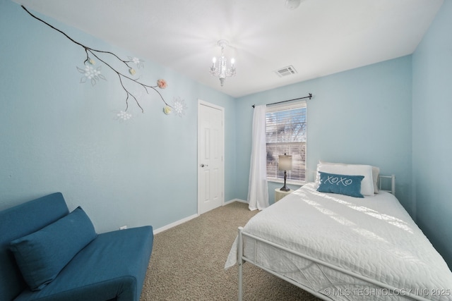 bedroom featuring carpet floors and a chandelier