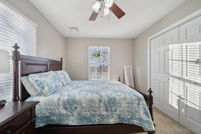 carpeted bedroom featuring a closet and ceiling fan