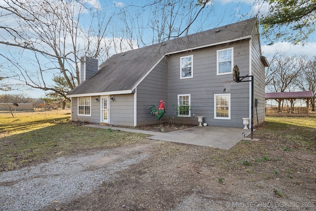 rear view of property featuring a patio area and a yard