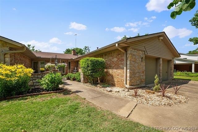 view of side of property with a garage and a yard