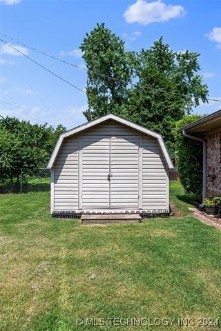 view of outbuilding featuring a yard