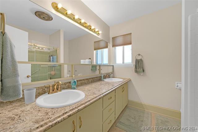 bathroom featuring an enclosed shower and vanity