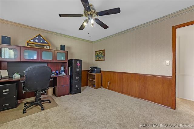 home office with ceiling fan, ornamental molding, and light carpet