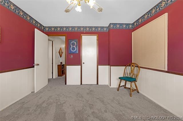 interior space with ceiling fan and light colored carpet