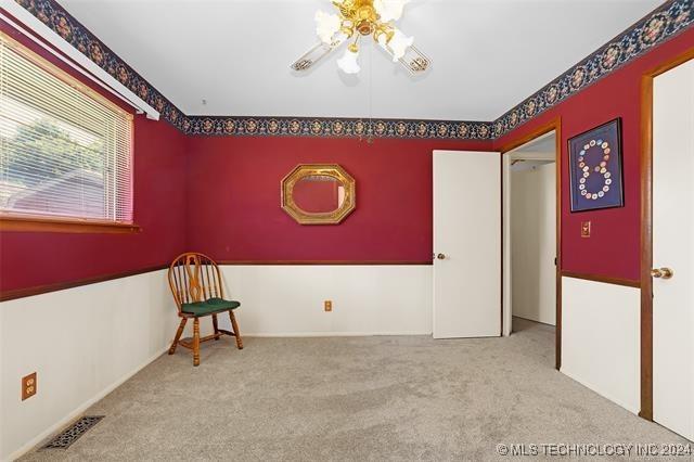 unfurnished room featuring light carpet and ceiling fan