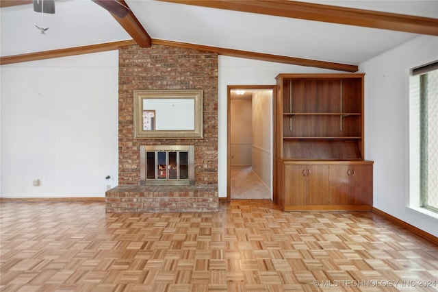 unfurnished living room featuring a brick fireplace, light parquet flooring, and lofted ceiling with beams