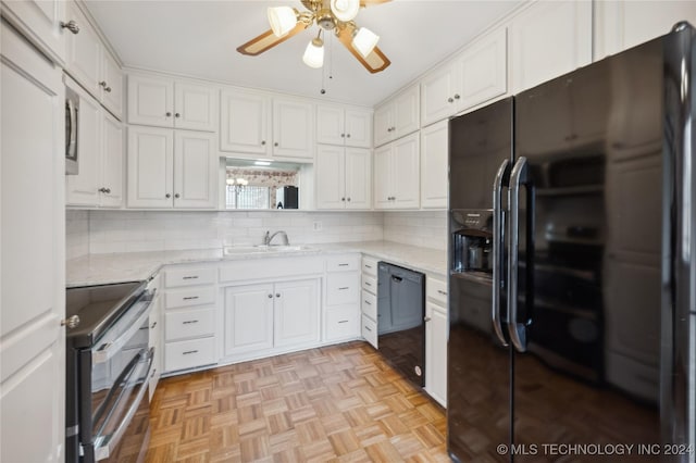 kitchen featuring light parquet floors, white cabinetry, black appliances, light stone counters, and sink