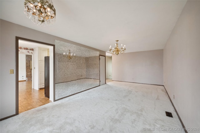 unfurnished bedroom with a chandelier and parquet flooring