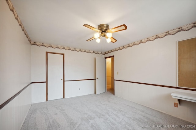 spare room featuring ceiling fan and light colored carpet