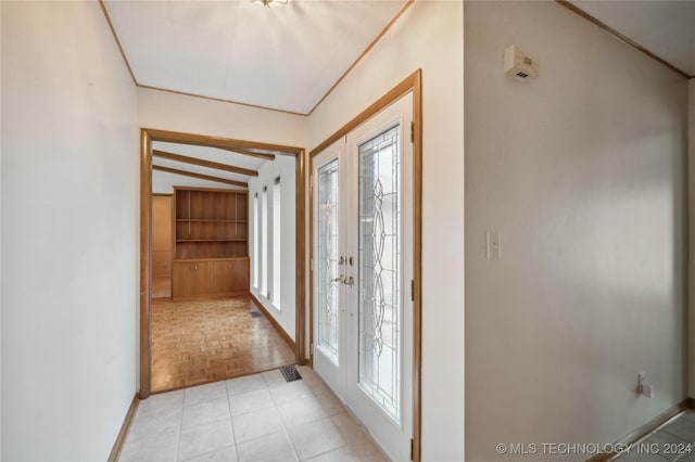 entrance foyer with lofted ceiling, french doors, and light parquet floors