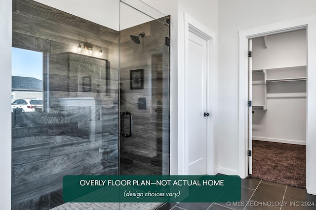 bathroom with tile patterned floors and a shower with door