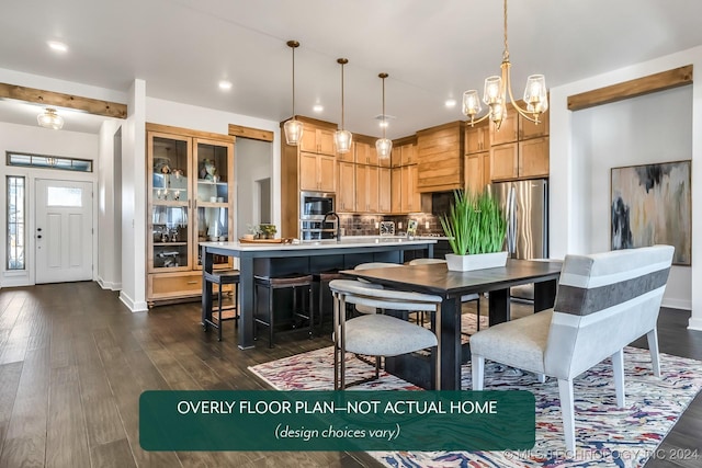 kitchen featuring pendant lighting, decorative backsplash, stainless steel appliances, and a kitchen island with sink