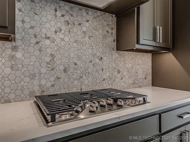 kitchen featuring decorative backsplash and stainless steel gas stovetop